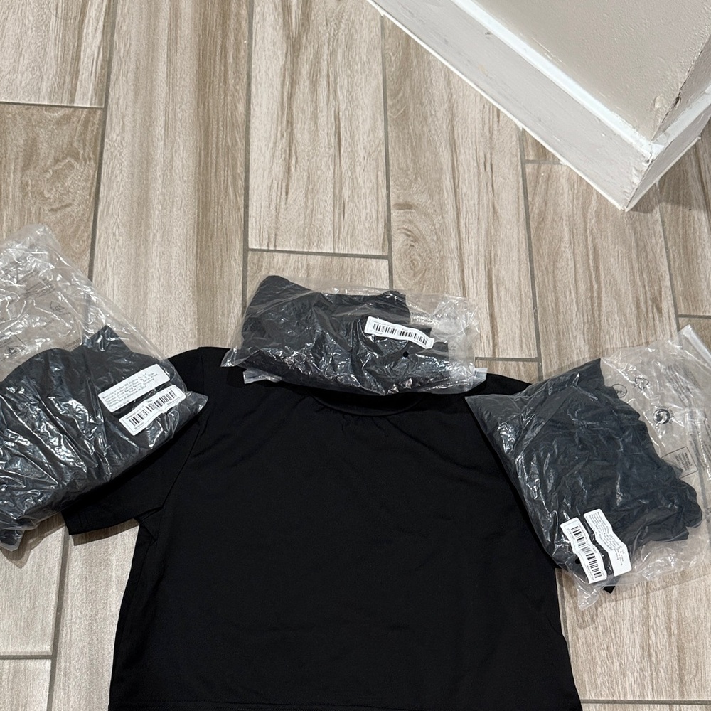Black Cropped Youth T-shirts. Quantity 4 (one size 9/10 and three size 11/12).